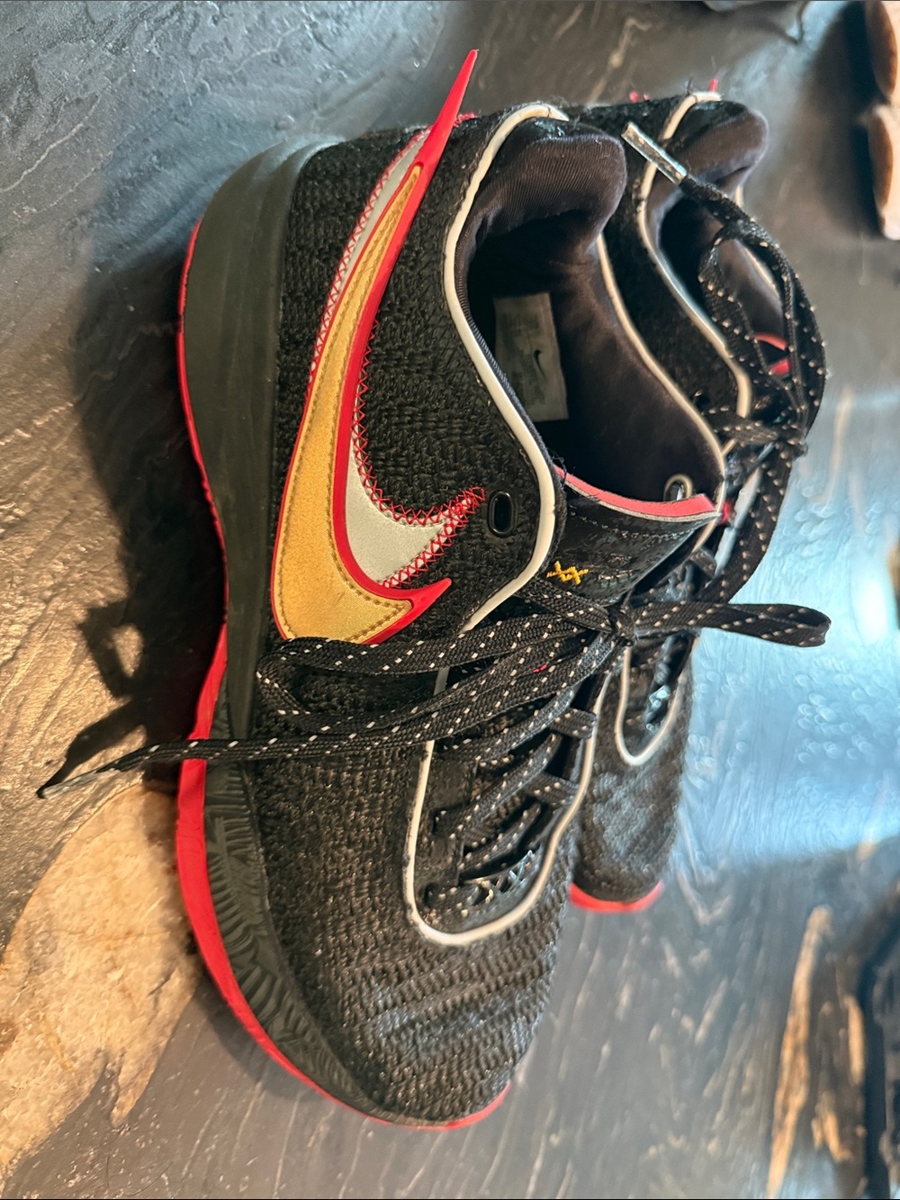 Nike Black Athletic Shoes with Red and Gold Swoosh